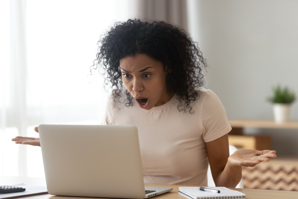 Shocked,angry,stressed,african,black,woman,customer,looking,at,laptop